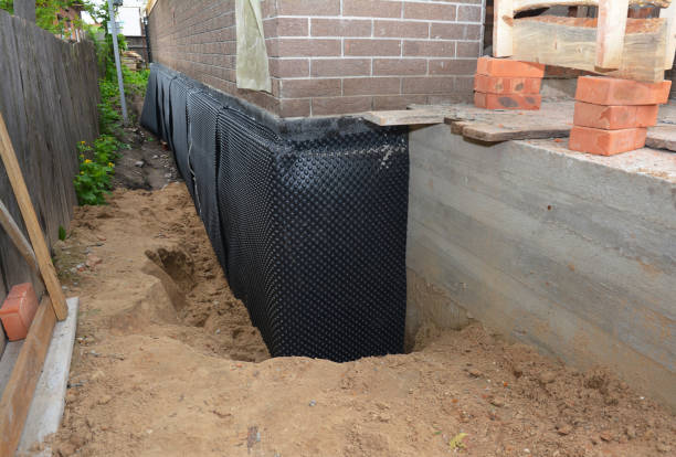 SJ Waterproofing Pros technician performing targeted Wet Basement Repair assessment in Lyndonville, NY